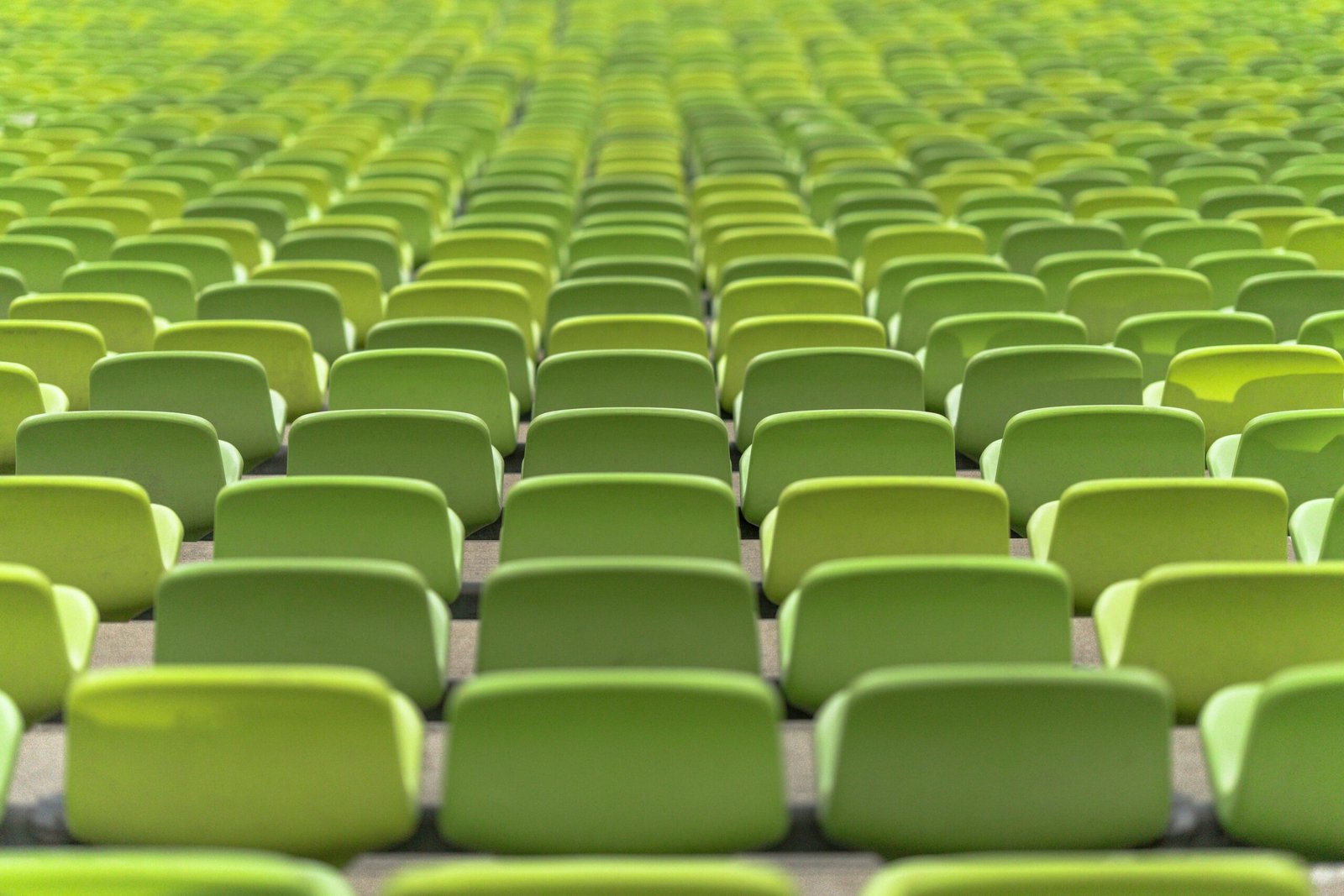 a row of green chairs sitting next to each other